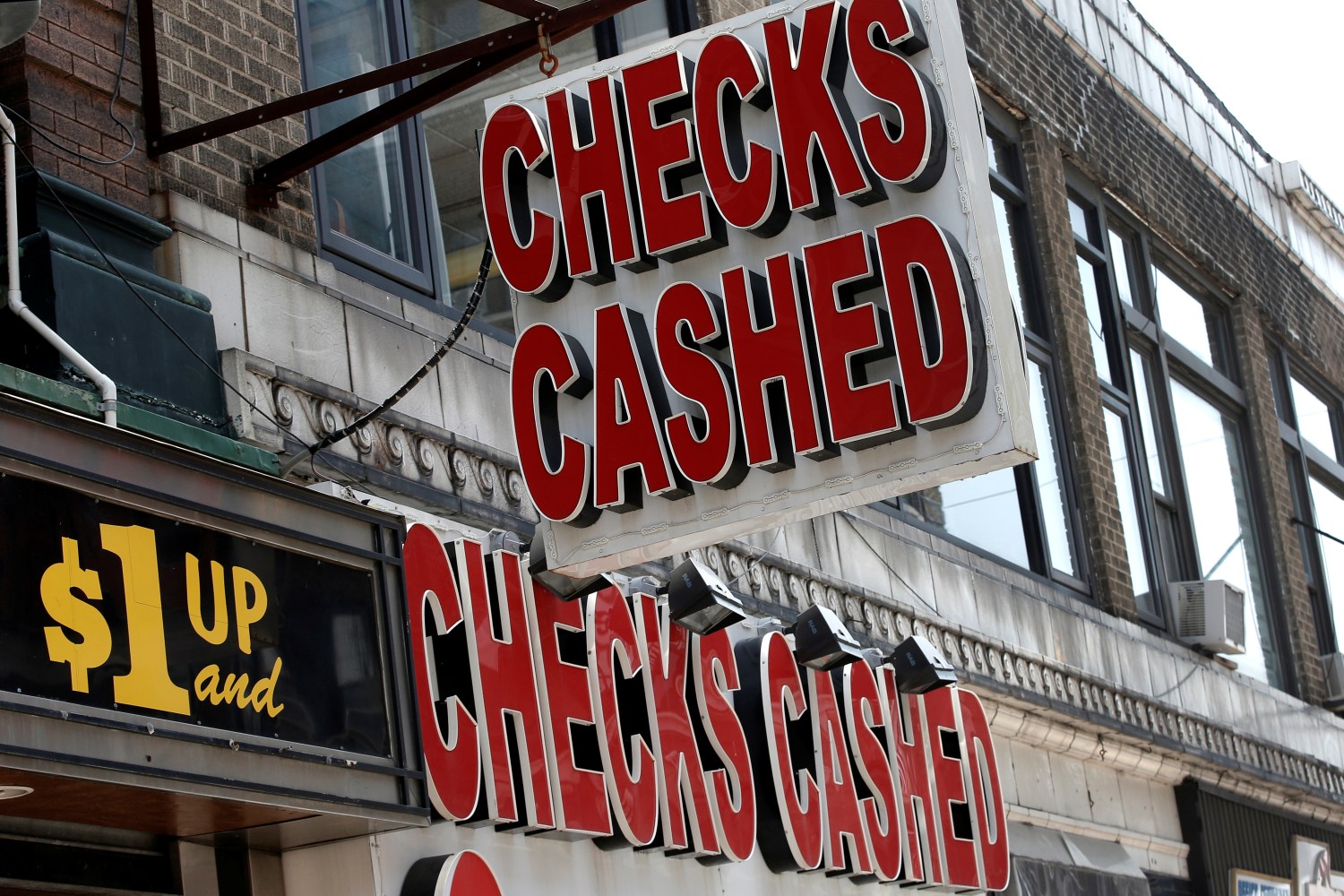 A sign is seen above a check cashing and loan shop in Jersey City.