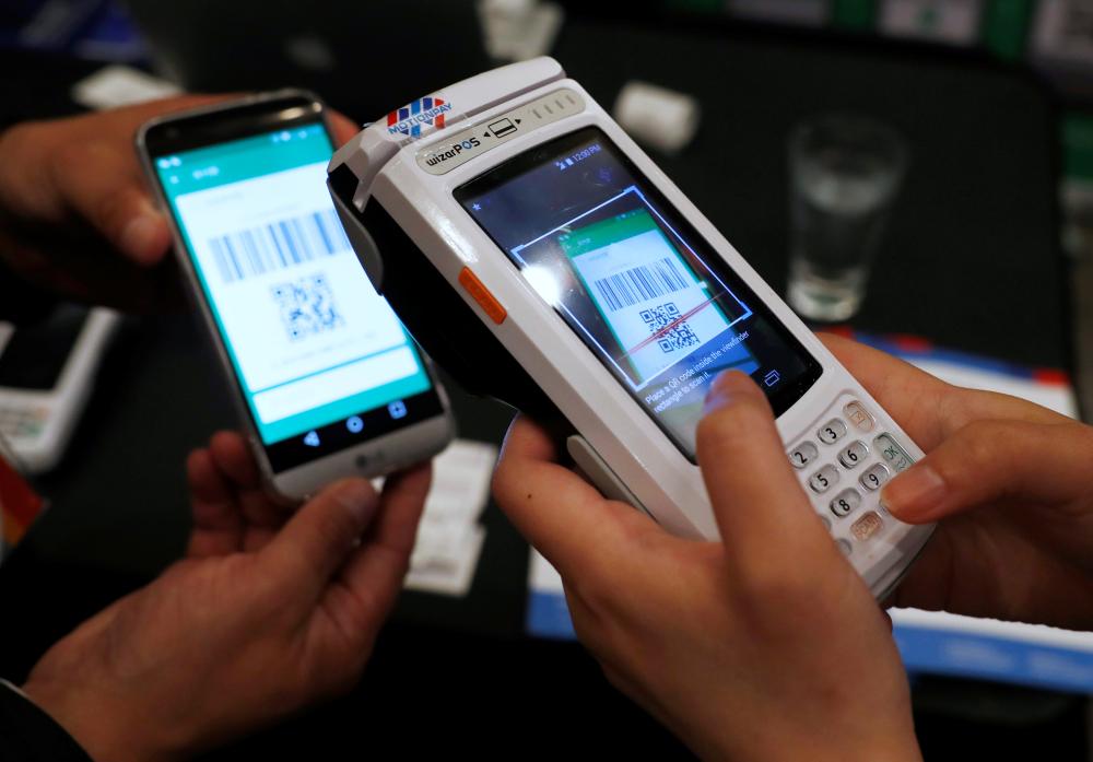 People demonstrate a digital money payment unit built by Motion Pay in Toronto