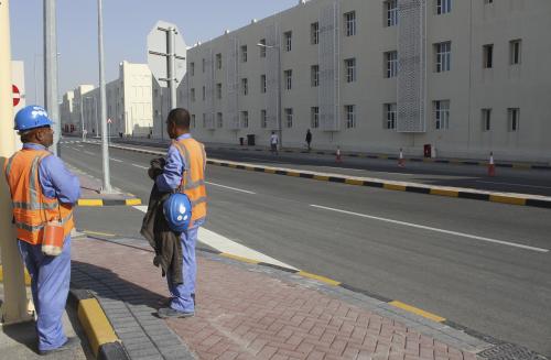 Workers stand at Labor City where migrant workers' accommodation is located in Qatar, January 13, 2016. REUTERS/Naseem Zeitoon