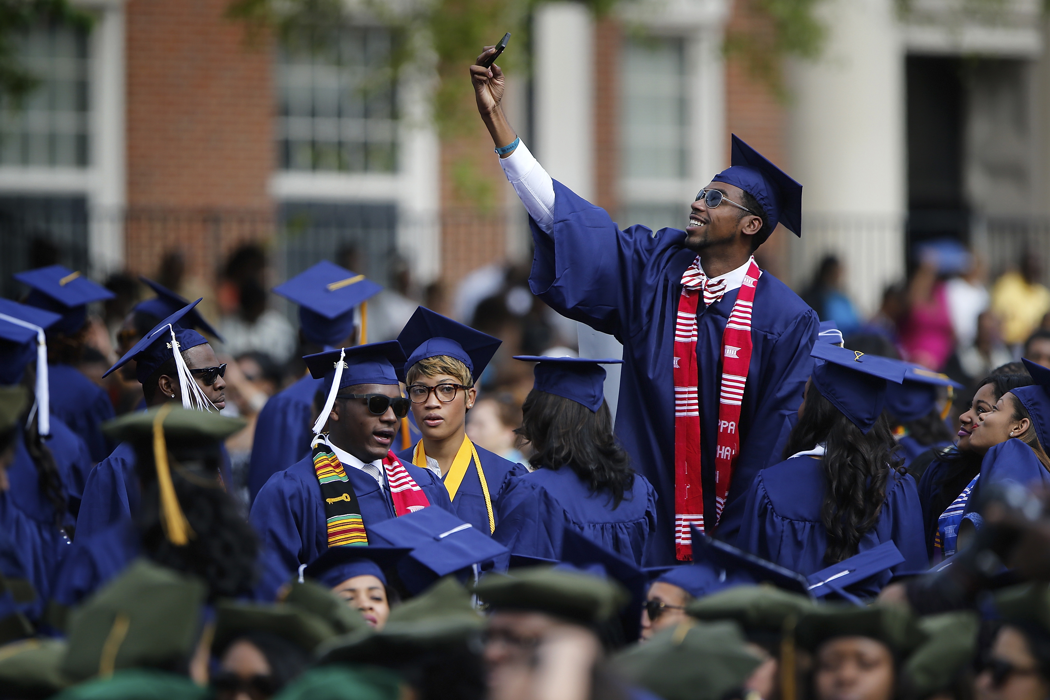 Graduates gather during 2014 commencement ceremonies at Howard University in Washington May 10, 2014. Entertainer Sean Combs delivered the commencement address and received an honorary degree in Humanities during the ceremony.    REUTERS/Jonathan Ernst    (UNITED STATES - Tags: EDUCATION ENTERTAINMENT SOCIETY) - GM1EA5B0DBF01