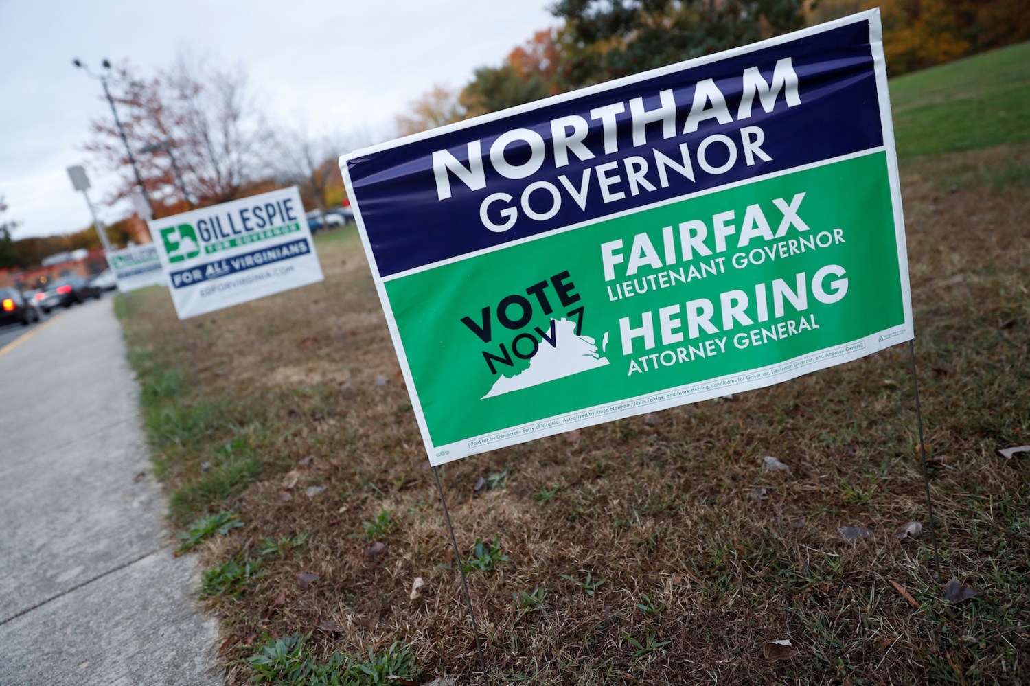 Campaign signs for Ed Gillespie and Ralph Northam are seen on Election Day at Washington Mill Elementary School in Alexandria, Virginia, U.S., November 7, 2017. REUTERS/Aaron P. Bernstein - RC15716CB9C0