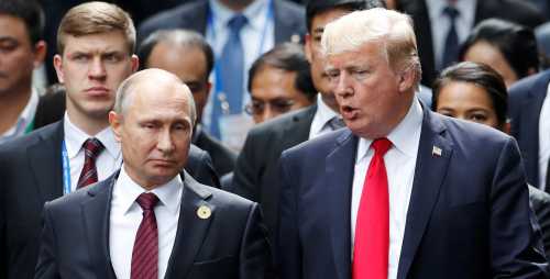 U.S. President Donald Trump and Russia's President Vladimir Putin talk during the family photo session at the APEC Summit in Danang, Vietnam November 11, 2017. REUTERS/Jorge Silva
