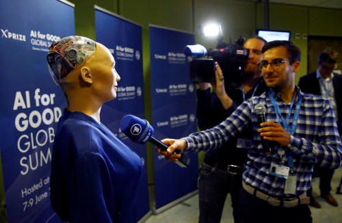 A TV crew interviews Sophia, a robot integrating the latest technologies and artificial intelligence