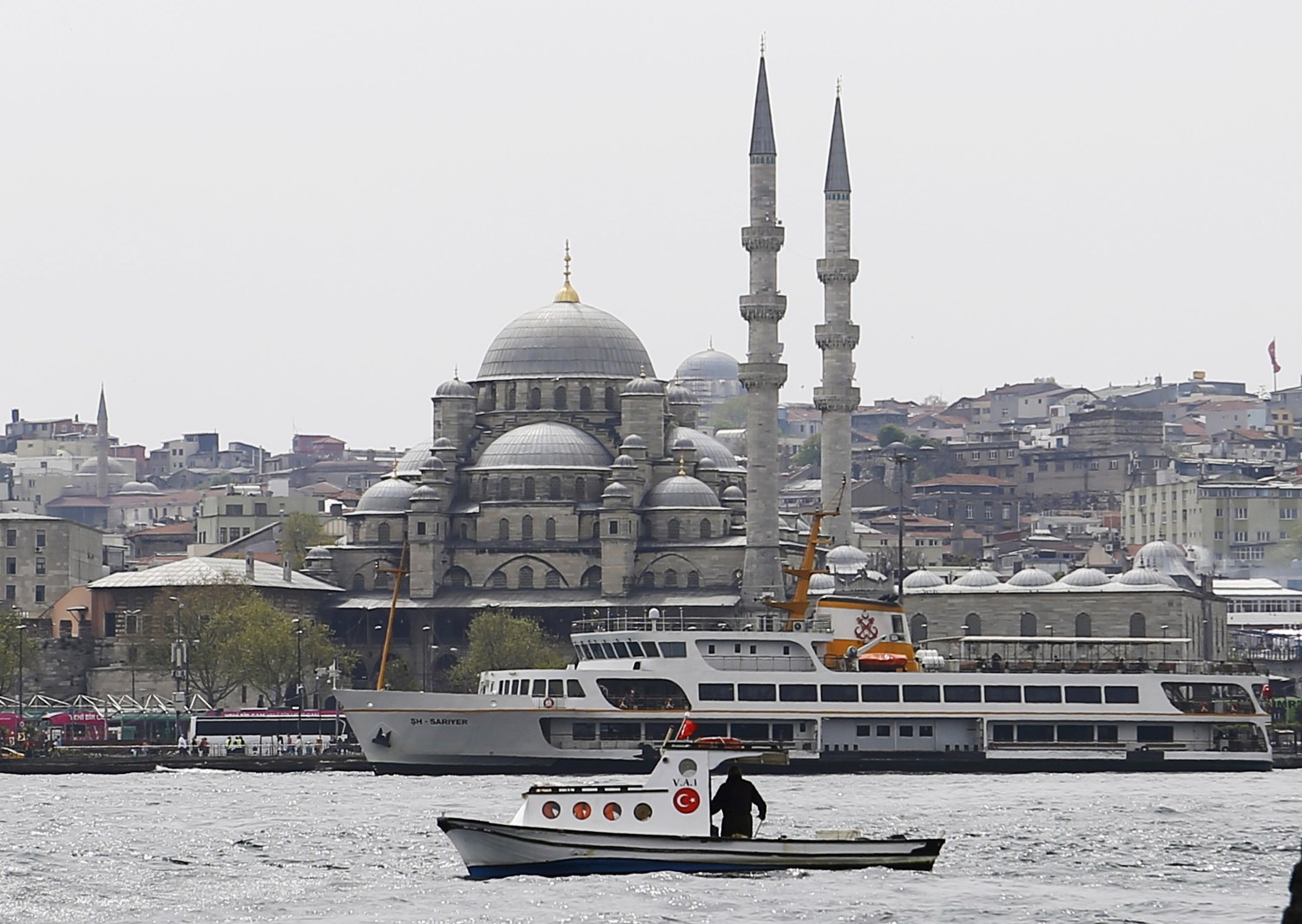 A fishing boat sails in the Golden Horn.