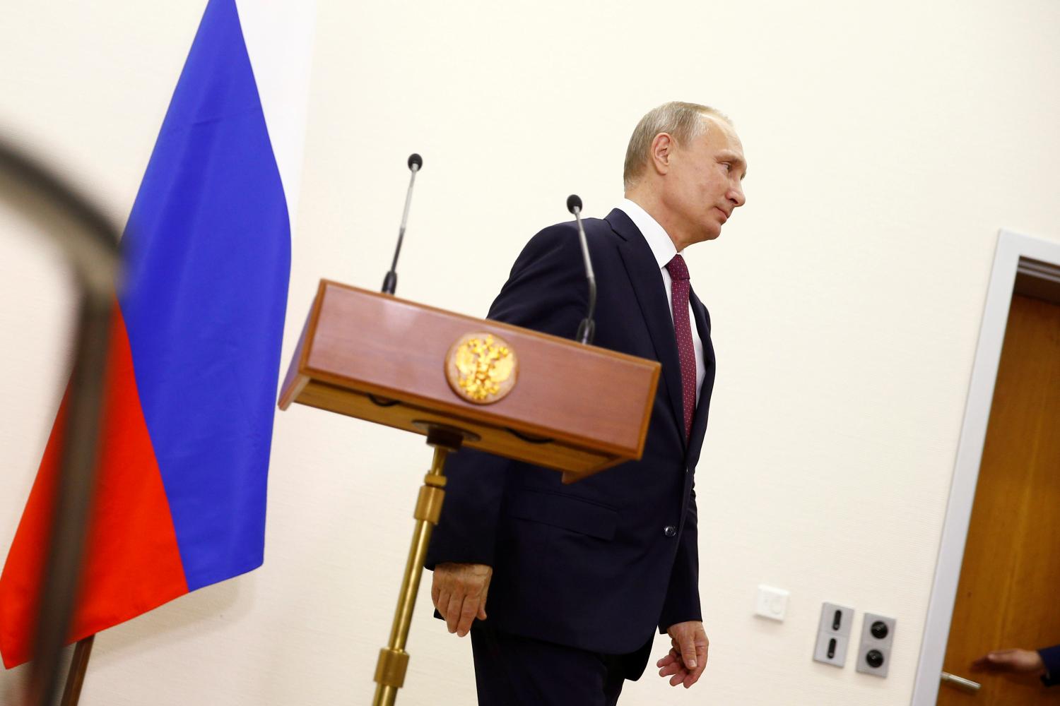 Russian President Vladimir Putin attends a press conference at Tegel airport after a meeting with German Chancellor Angela Merkel in Berlin