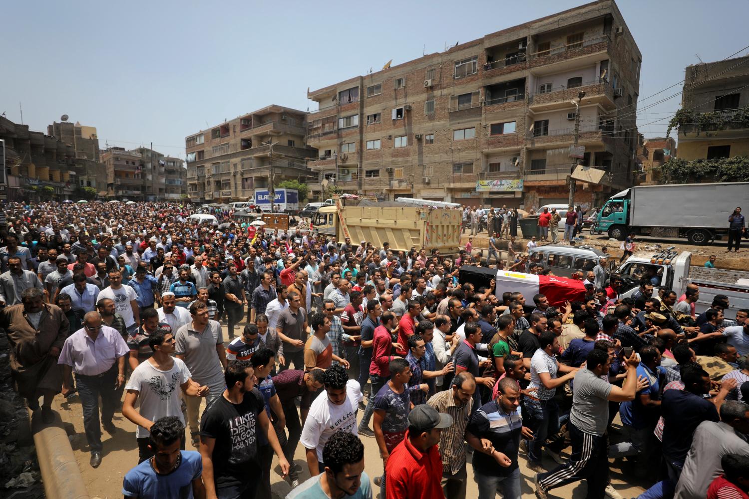 Egyptian relatives and friends carry the coffin of the officer Khaled al-Maghrabi, who was killed during a suicide bomb attack on an army checkpoint in Sinai, during his funeral in his hometown Toukh, Al Qalyubia Governorate, north of Cairo, Egypt 8 July, 2017. REUTERS/Mohamed Abd El Ghany - RC195508E300