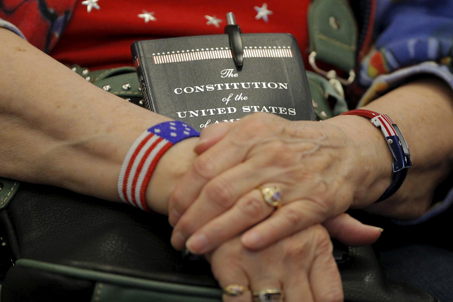 An audience member holds a copy of the U.S. Constitution during a campaign stop with U.S. Republican presidential candidate and U.S. Senator Marco Rubio in Des Moines