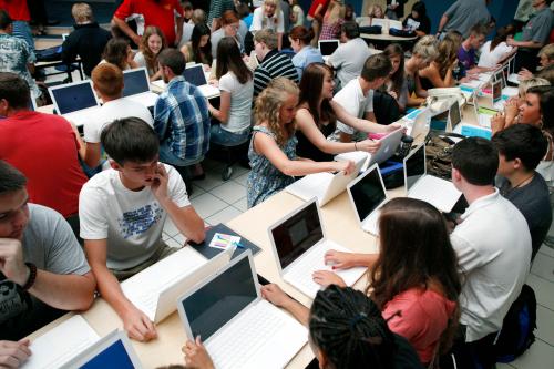 Students set up their donated laptop computers on the first day of school at Joplin High School in Joplin