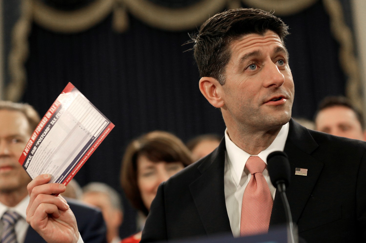 Speaker of the House Paul Ryan (R-WI) holds a sample tax form as he unveils legislation to overhaul the tax code.