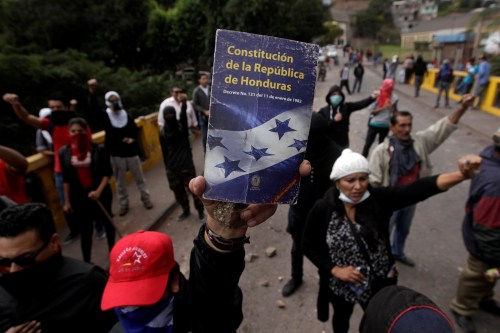An opposition supporter holds up the Constitution of the Republic of Honduras during a protest over a contested presidential election with allegations of electoral fraud in Tegucigalpa, Honduras, December 22, 2017. REUTERS/Jorge Cabrera TPX IMAGES OF THE DAY - RC196841EE20