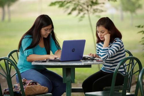 A woman works on her computer at a coffee shop in Ciudad Juarez, October 19, 2017. Picture taken October 19, 2017. REUTERS/Jose Luis Gonzalez - RC13F350DE70