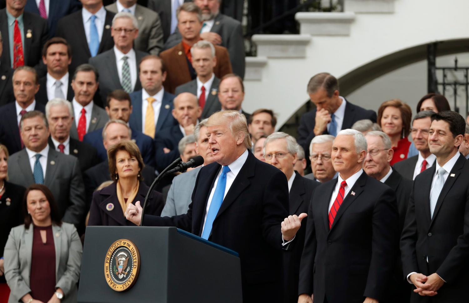 President Trump and Congressional Republicans celebrate after Congress passed sweeping tax overhaul legislation.