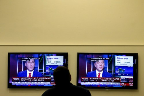 A trader watches, as a television displays the news about former U.S. national security adviser Michael Flynn, at the New York Stock Exchange, (NYSE) in New York, U.S., December 1, 2017. REUTERS/Brendan McDermid - RC18062BEA70