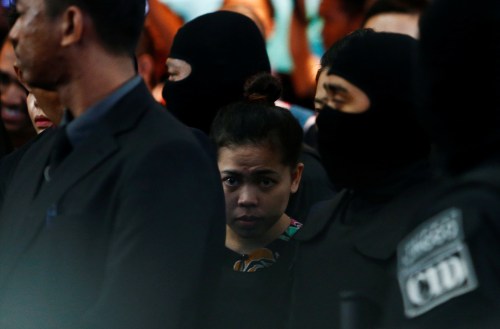 Indonesian Siti Aisyah, who is on trial for the killing of Kim Jong Nam, the estranged half-brother of North Korea's leader, is escorted as she revisits the Kuala Lumpur International Airport 2 in Sepang, Malaysia October 24, 2017. REUTERS/Lai Seng Sin