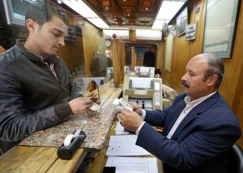 A customer exchanges U.S. dollars to Egyptian pounds in a foreign exchange office in central Cairo, Egypt, March 7, 2017. REUTERS/Mohamed Abd El Ghany