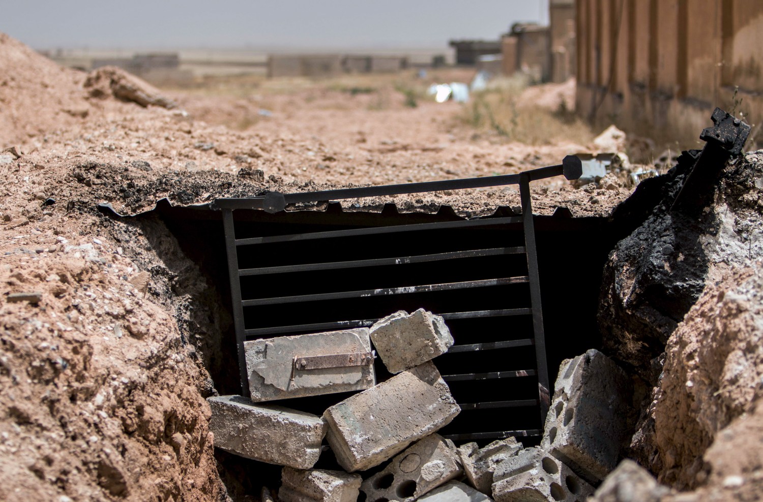 A view shows the entrance of a tunnel used by Islamic State fighters as a shelter in the town of al-Mabroukah after the Kurdish People's Protection Units (YPG) they took control of the area May 28, 2015. A Syrian Kurdish militia has captured a town from Islamic State in the northeast, a group monitoring the war reported on Wednesday, compounding recent losses for the jihadists in a strategic corner of Syria. The capture of the town of al-Mabroukah by the YPG militia opens the road for its forces to advance towards the Islamic State's stronghold in Raqqa province, the Syrian Observatory for Human Rights reported. REUTERS/Rodi Said - GF10000110254