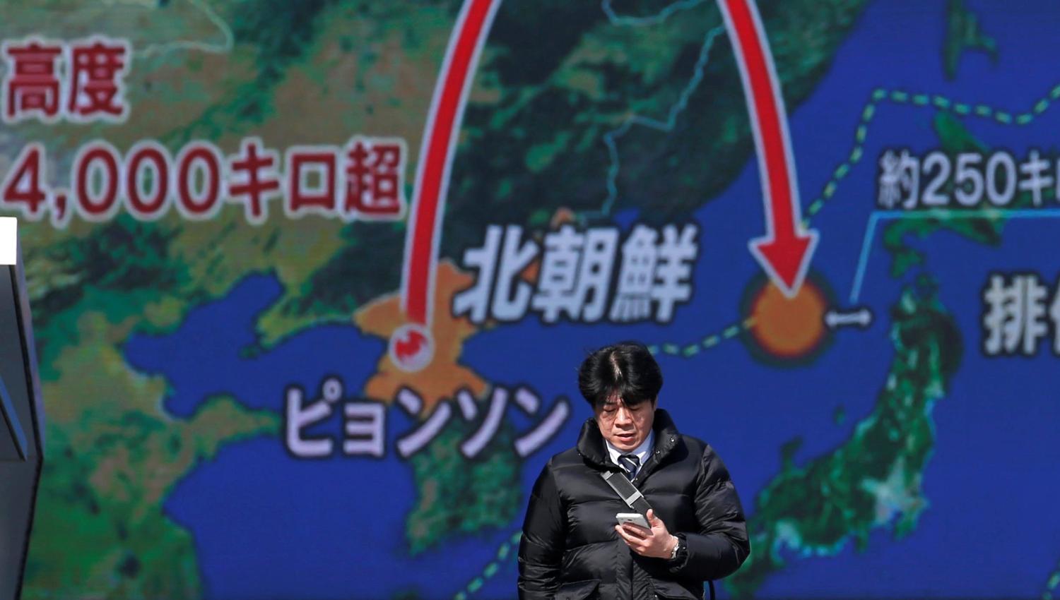 A man walks past a street monitor showing a news report about North Korea's missile launch, in Tokyo, Japan, November 29, 2017. REUTERS/Toru Hanai - RC14E67BAE70