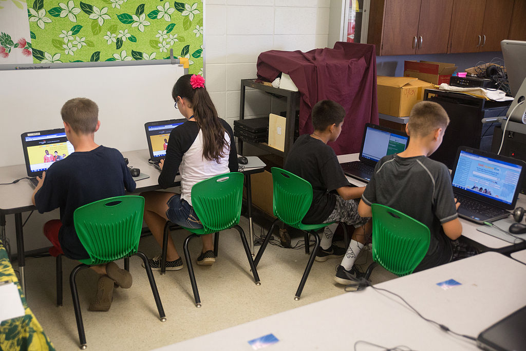 Young school children at computer desks