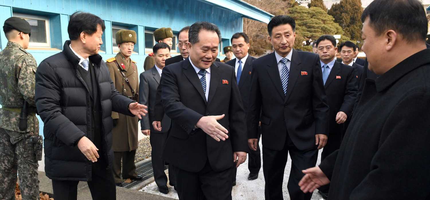Head of North Korean delegation Ri Son Gwon, Chairman of the Committee for the Peaceful Reunification of the Country (CPRC) of DPRK, reaches out to shake hands with a South Korean official as he crosses a concrete border to attend their meeting at the truce village of Panmunjom in the demilitarised zone separating the two Koreas, South Korea, January 9, 2018. REUTERS/Korea Pool - RC11892B1F30