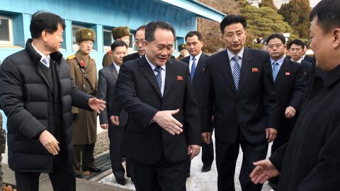 Head of North Korean delegation Ri Son Gwon, Chairman of the Committee for the Peaceful Reunification of the Country (CPRC) of DPRK, reaches out to shake hands with a South Korean official as he crosses a concrete border to attend their meeting at the truce village of Panmunjom in the demilitarised zone separating the two Koreas, South Korea, January 9, 2018.   REUTERS/Korea Pool - RC11892B1F30
