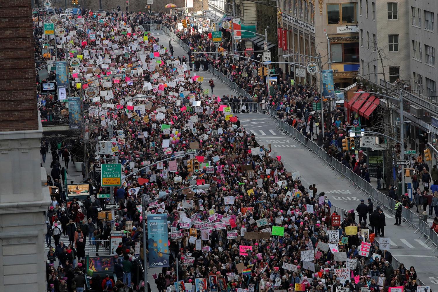 People walk down Sixth Avenue as they participate in the Women's March in Manhattan, New York City, New York, U.S., January 20, 2018. REUTERS/Andrew Kelly - RC1878B29720