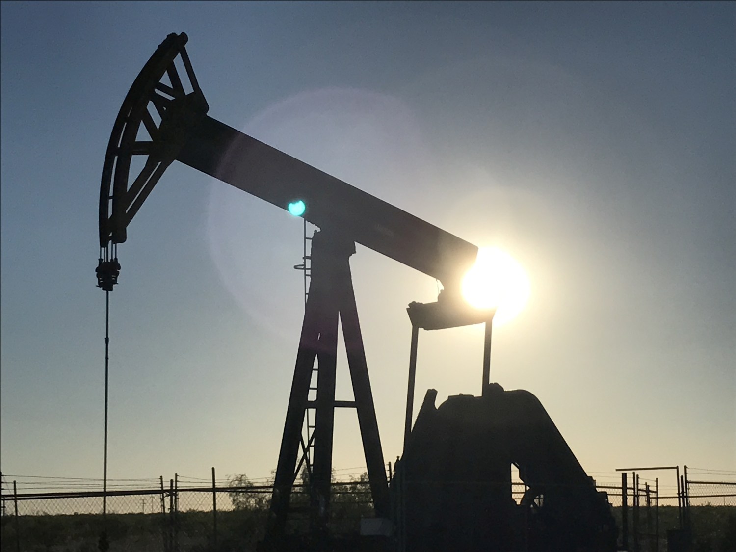 An oil pump at sunrise, owned by Parsley Energy Inc. near Midland, Texas, U.S., May 3, 2017. Picture taken May 3, 2017. REUTERS/Ernest Scheyder - RC1509840B40