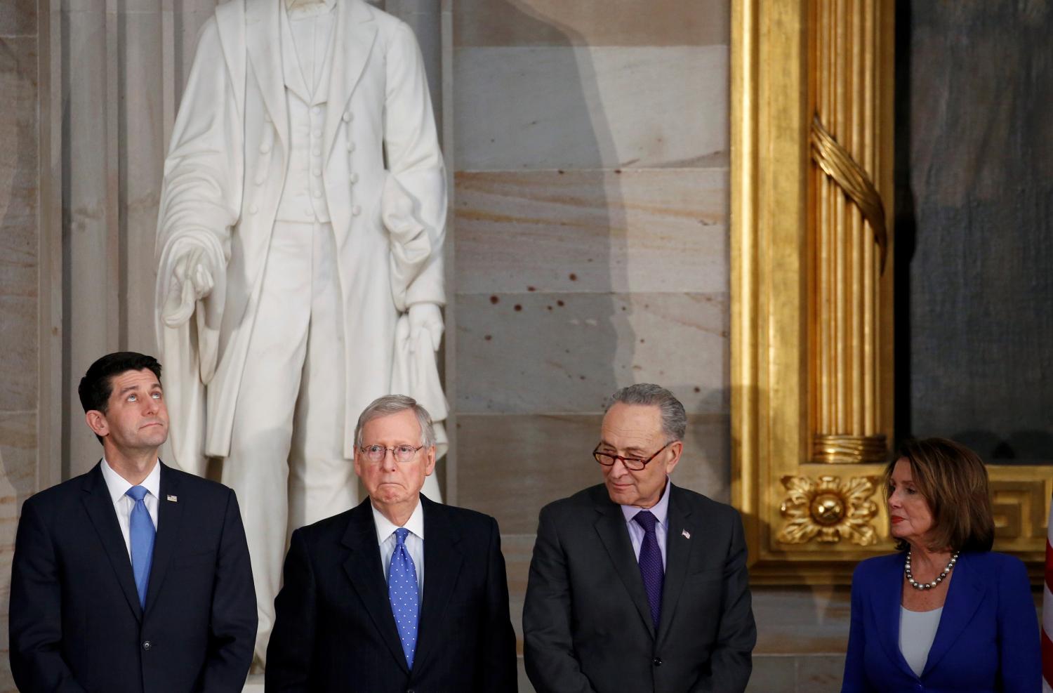 Speaker of the House Paul Ryan (R-WI), Senate Majority Leader Mitch McConnell (R-KY), Senate Minority Leader Chuck Schumer (D-NY) and House Minority Leader Nancy Pelosi (D-CA) stand during a Congressional Gold Medal ceremony honoring former Senate majority leader Bob Dole (R-KS) on Capitol Hill in Washington, U.S., January 17, 2018. REUTERS/Joshua Roberts - RC154A11A3F0