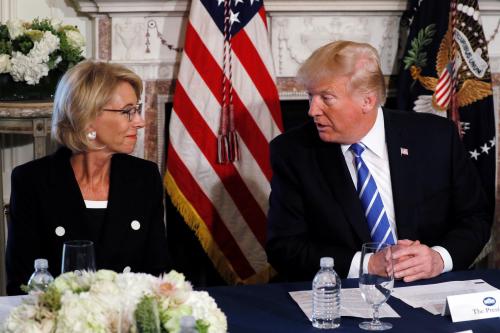 U.S. President Donald Trump turns to Education Secretary Betsy DeVos (L) during his remarks to reporters before a workforce apprenticeship discussion at Trump's golf estate in Bedminster, New Jersey U.S. August 11, 2017. REUTERS/Jonathan Ernst - RC164E2DD650