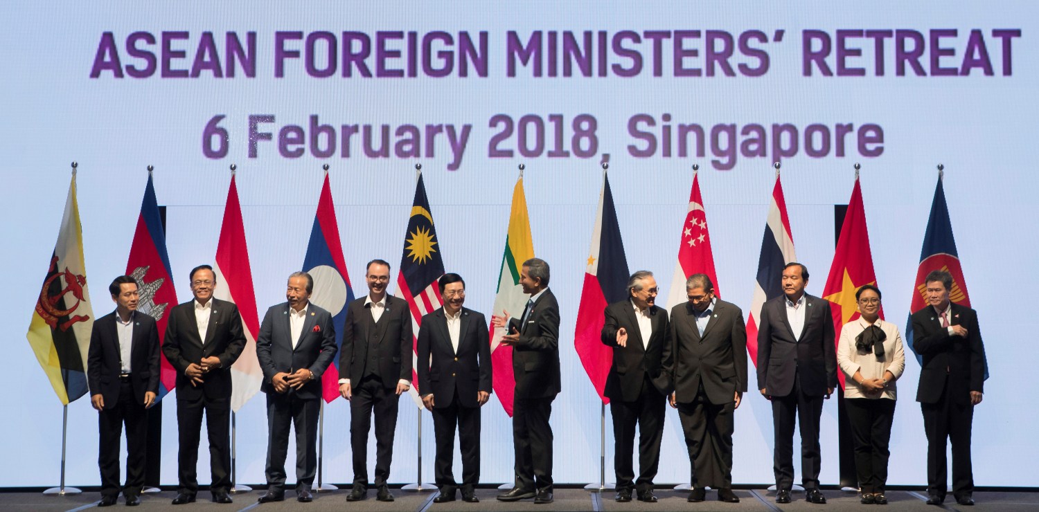 Foreign ministers prepare to pose for a group photo at the Association of Southeast Asian Nations (ASEAN) Foreign Ministers' Meeting retreat in Singapore February 6