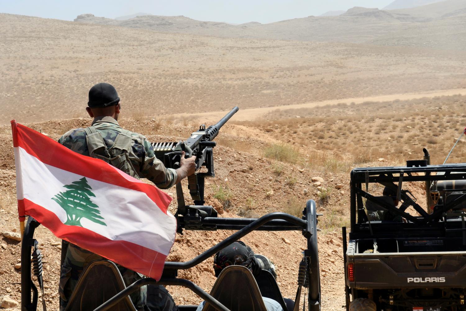 Lebanese Army soldiers ride on their military vehicles in Ras Baalbek