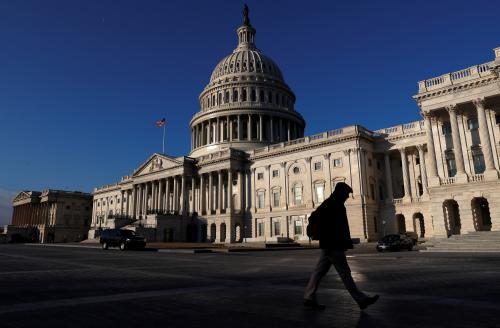 People walk by the U.S. Capitol building in Washington, U.S., February 8, 2018. REUTERS/ Leah Millis - RC13737E70C0