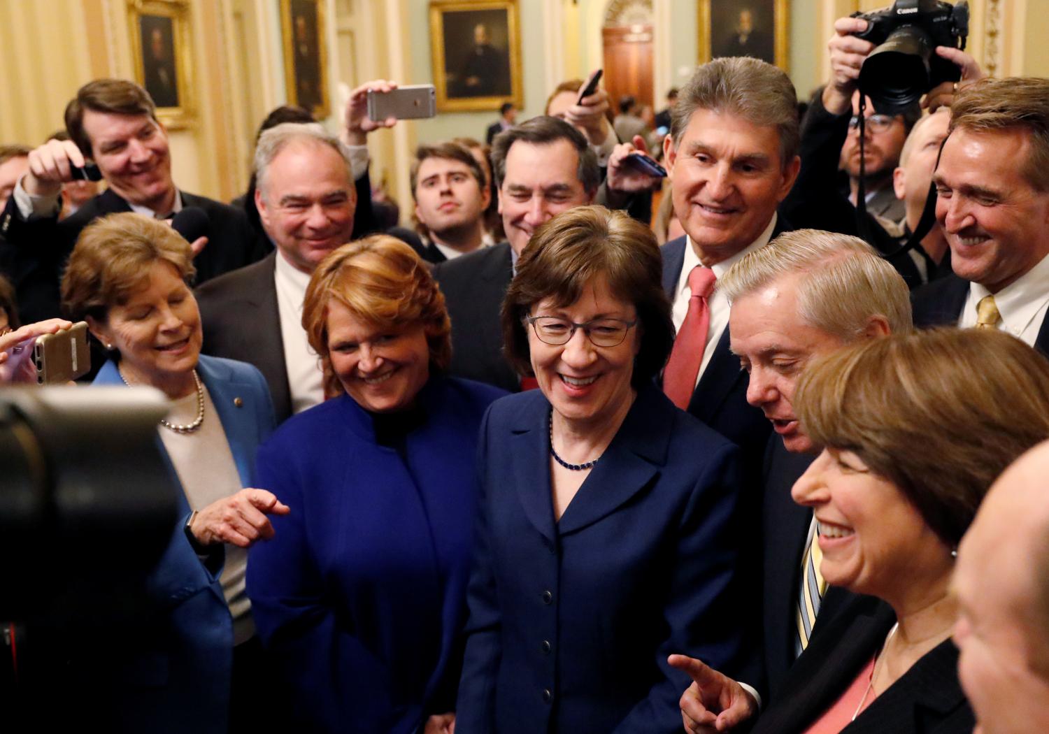 U.S. Senators' Susan Collins (R-ME) addresses reporters with fellow Senators' Jeanne Shaheen (D-NH), Tim Kaine (D-VA), Heidi Heitkamp (D-ND), Joe Manchin (D-WV), Lindsey Graham (R-SC), Amy Klobuchar (D-MN) and Jeff Flake (R-AZ) after lawmakers struck a deal to reopen the federal government.