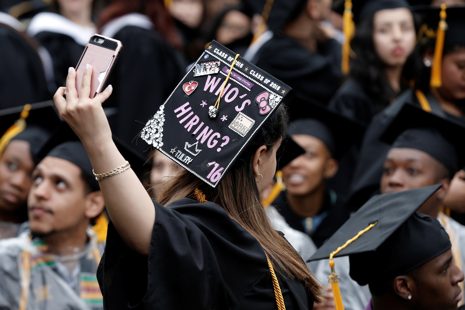 A graduating student of the City College of New York takes a selfie of the message on her cap during the College's commencement ceremony.