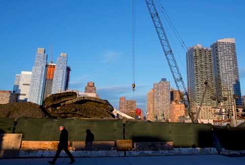 A man passes by a construction site.