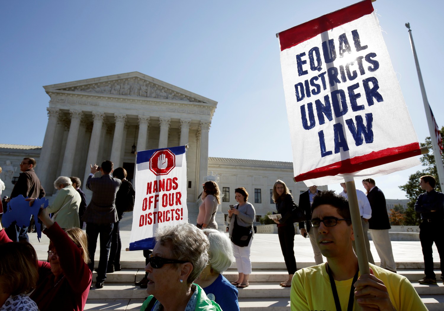 Demonstrators rally during oral arguments in Gill v. Whitford, a case about partisan gerrymandering in electoral districts, at the Supreme Court in Washington