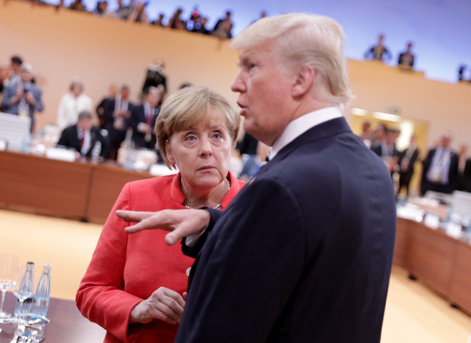 U.S. President Donald Trump talks to German Chancellor Angela Merkel before the first working session of the G20 meeting in Hamburg, Germany, July 7, 2017. REUTERS/Kay Nietfeld,Pool - RC1C9C45A9E0