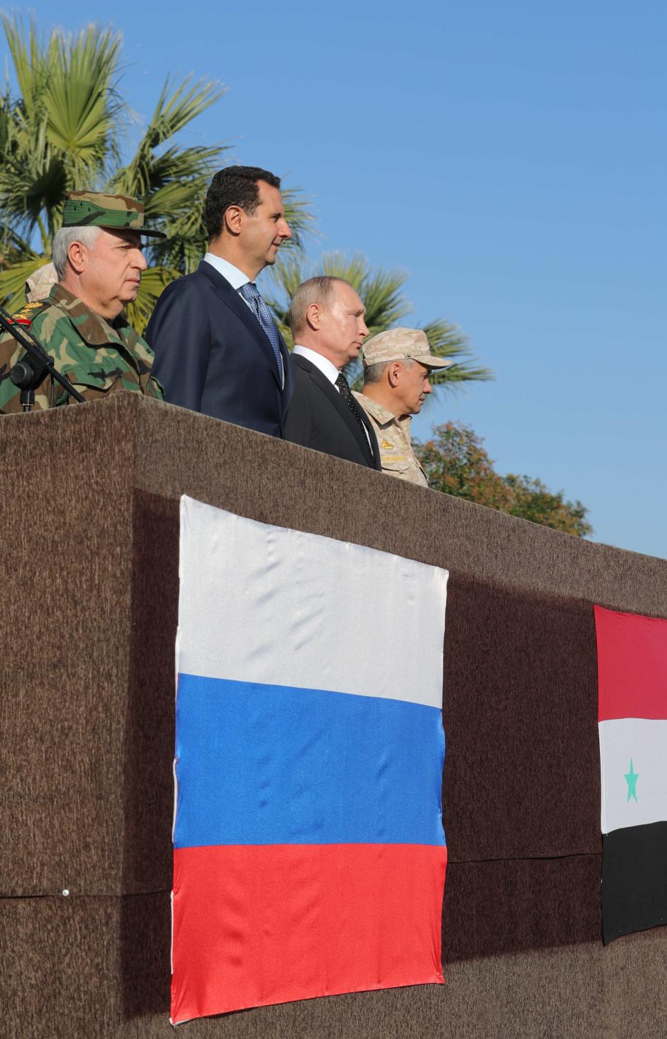 Russian President Vladimir Putin (2nd R), Defence Minister Sergei Shoigu (R) and Syrian President Bashar al-Assad (2nd L) visit the Hmeymim air base in Latakia Province, Syria December 11, 2017. Sputnik/Mikhail Klimentyev/Sputnik via REUTERS ATTENTION EDITORS - THIS IMAGE WAS PROVIDED BY A THIRD PARTY. TPX IMAGES OF THE DAY - RC1CC01C9AF0