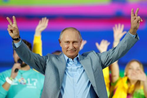 Russian President Vladimir Putin waves to participants of the 19th World Festival of Youth and Students during the closing ceremony at the Olympic Park in Sochi, Russia October 21, 2017. REUTERS/Alexander Zemlianichenko/Pool TPX IMAGES OF THE DAY - RC13EB6A1380