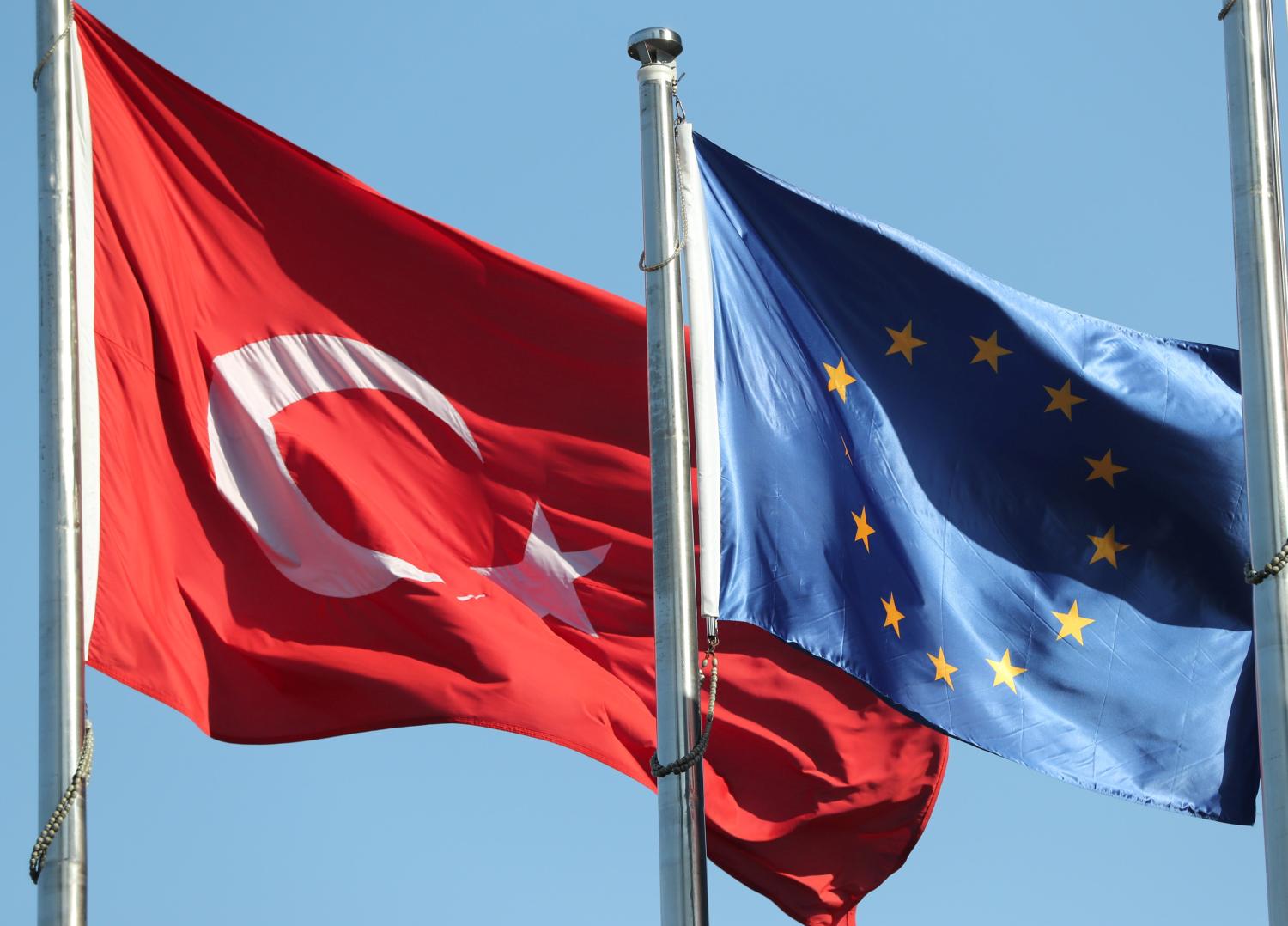 European Union (R) and Turkish flags fly at the business and financial district of Levent in Istanbul, Turkey September 4, 2017.