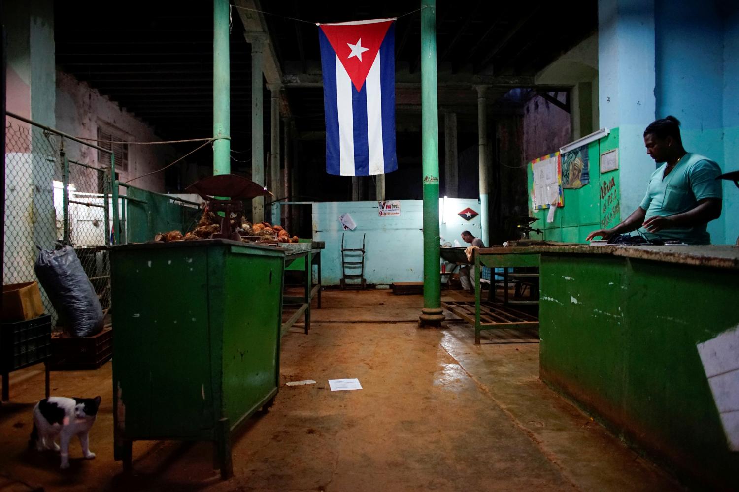 A Cuban flag decorates a subsidised state store, or "bodega", where Cubans can buy basic products with a ration book they receive annually from the government, in downtown Havana