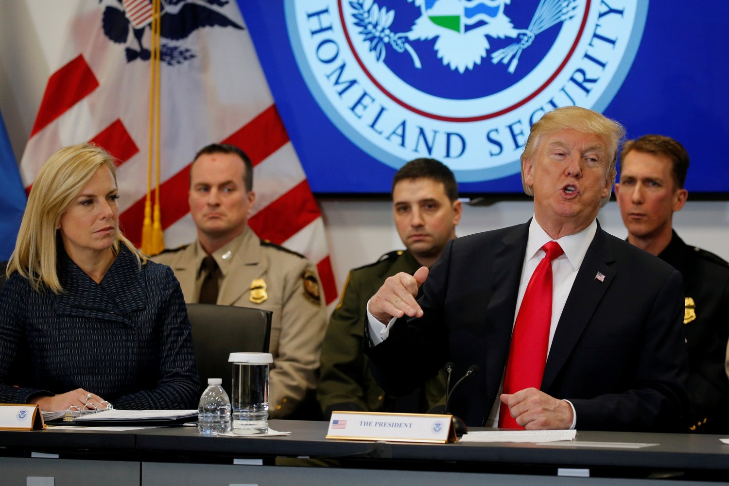 U.S. President Donald Trump, flanked by Secretary of Homeland Security Kirstjen Nielsen (L), holds a meeting at the U.S. Customs and Border Protection's National Targeting Center in Sterling, Virginia, U.S. February 2, 2018. REUTERS/Jonathan Ernst - RC1DC1FFCA00