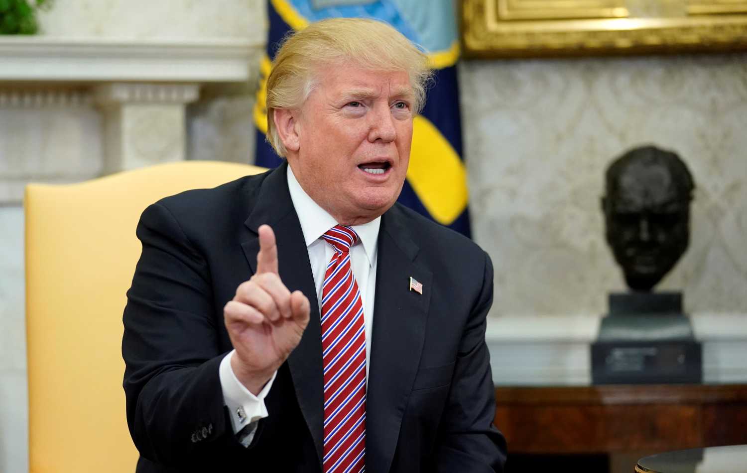 U.S. President Donald Trump declares his opposition to domestic violence during a working session regarding the Opportunity Zones provided by tax reform in the Oval Office of the White House in Washington, U.S., February 14, 2018. REUTERS/Joshua Roberts - RC11BECC88B0