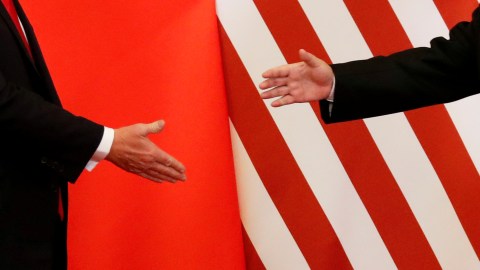 U.S. President Donald Trump and China's President Xi Jinping shake hands after making joint statements at the Great Hall of the People in Beijing, China, November 9, 2017. Damir Sagolj: "It's one of those "how to make a better or at least different shot when two presidents shake hands several times a day, several days in row". If I'm not mistaken in calculation, presidents Xi Jinping of China and Donald Trump of the U.S. shook their hands at least six times in events I covered during Trump's recent visit to China. I would imagine there were some more handshakes I haven't seen but other photographers did. And they all look similar - two big men, smiling and heartily greeting each other until everyone gets their shot. But then there is always something that can make it special - in this case the background made of U.S. and Chinese flags. They shook hands twice in front of it, and the first time it didn't work for me. The second time I positioned myself lower and centrally, and used the longest lens I have to capture only hands reaching for a handshake." REUTERS/Damir Sagolj/File Photo  SEARCH "POY TRUMP" FOR THIS STORY. SEARCH "REUTERS POY" FOR ALL BEST OF 2017 PACKAGES.    TPX IMAGES OF THE DAY - RC1B1E5EF340