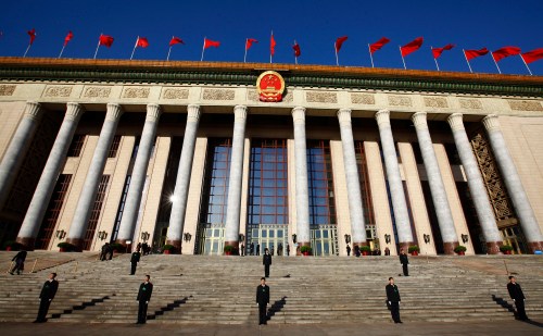 Security officers stand guard outside the Great Hall of the People during the third plenary session of the National People's Congress (NPC) in Beijing March 10, 2013.