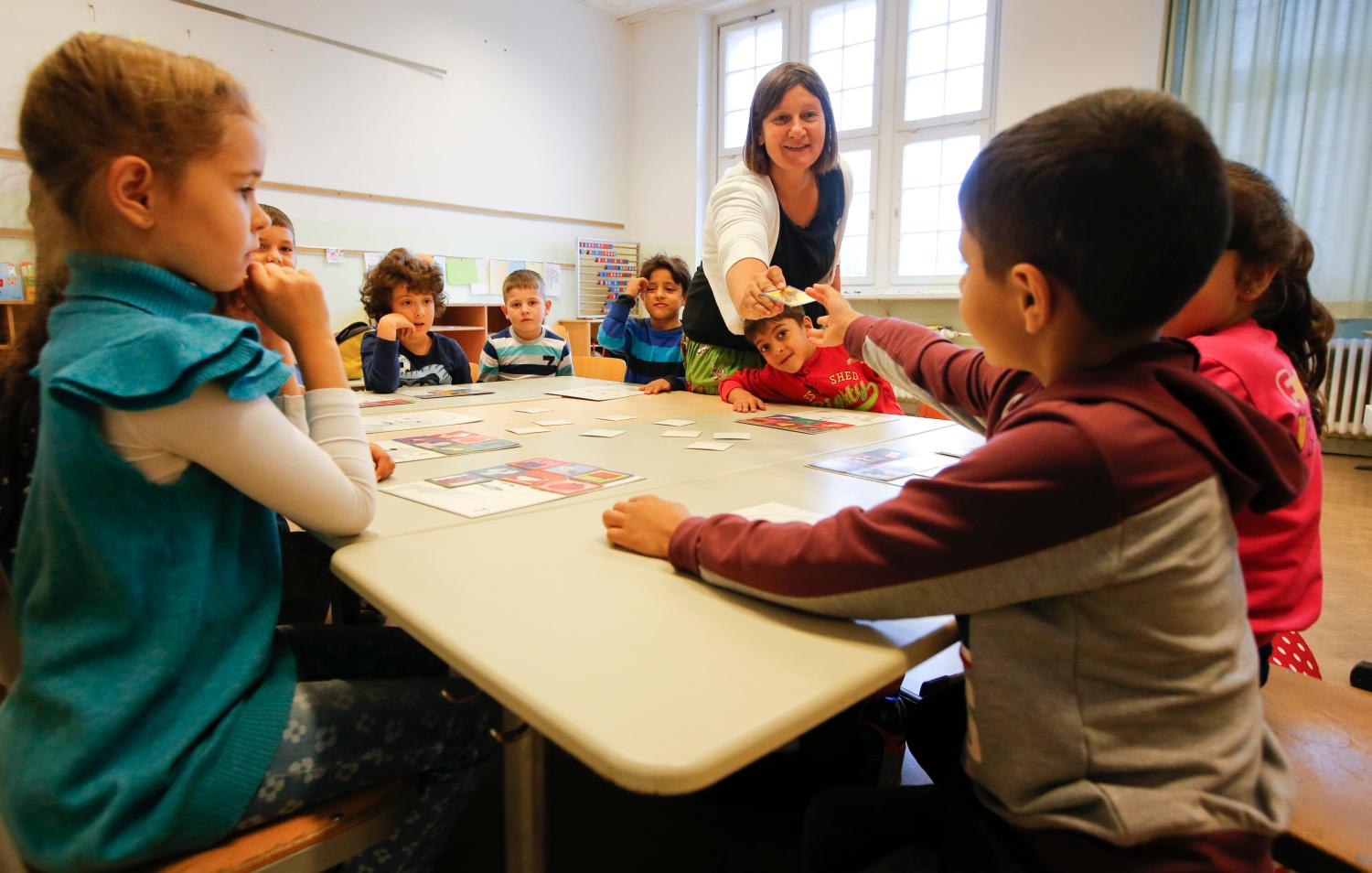 A teacher conducts a lesson in a classroom