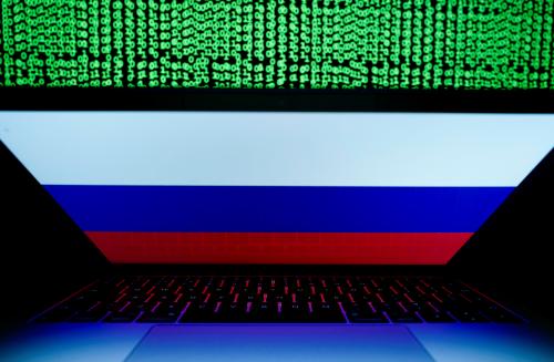 A Russian flag is seen on the laptop screen in front of a computer screen on which cyber code is displayed, in this illustration picture taken March 2, 2018. REUTERS/Kacper Pempel/Illustration - RC14D15692A0