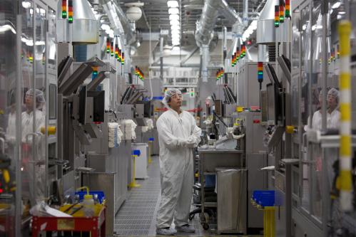 Production operator Sammy Blanco monitors multi colored lights atop automated machines at the SolarWorld solar panel factory in Hillsboro, Oregon, U.S., January 15, 2018.