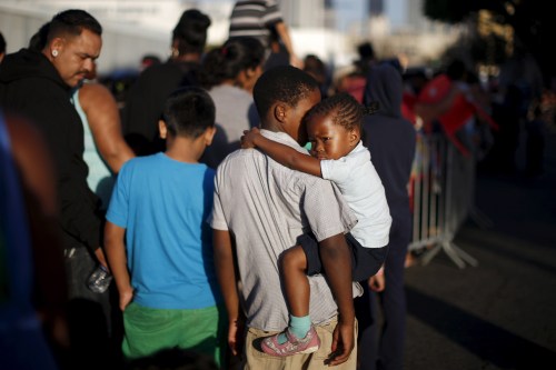People wait in line at the Fred Jordan Mission annual back to school giveaway of shoes, clothing and backpacks for more than 4,000 homeless and underprivileged children in Los Angeles, California, United States, October 1, 2015.