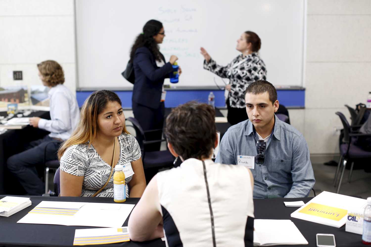 Job seekers work with recruiters at GRID Alternatives solar job fair in San Francisco, California, U.S. July 15, 2015.