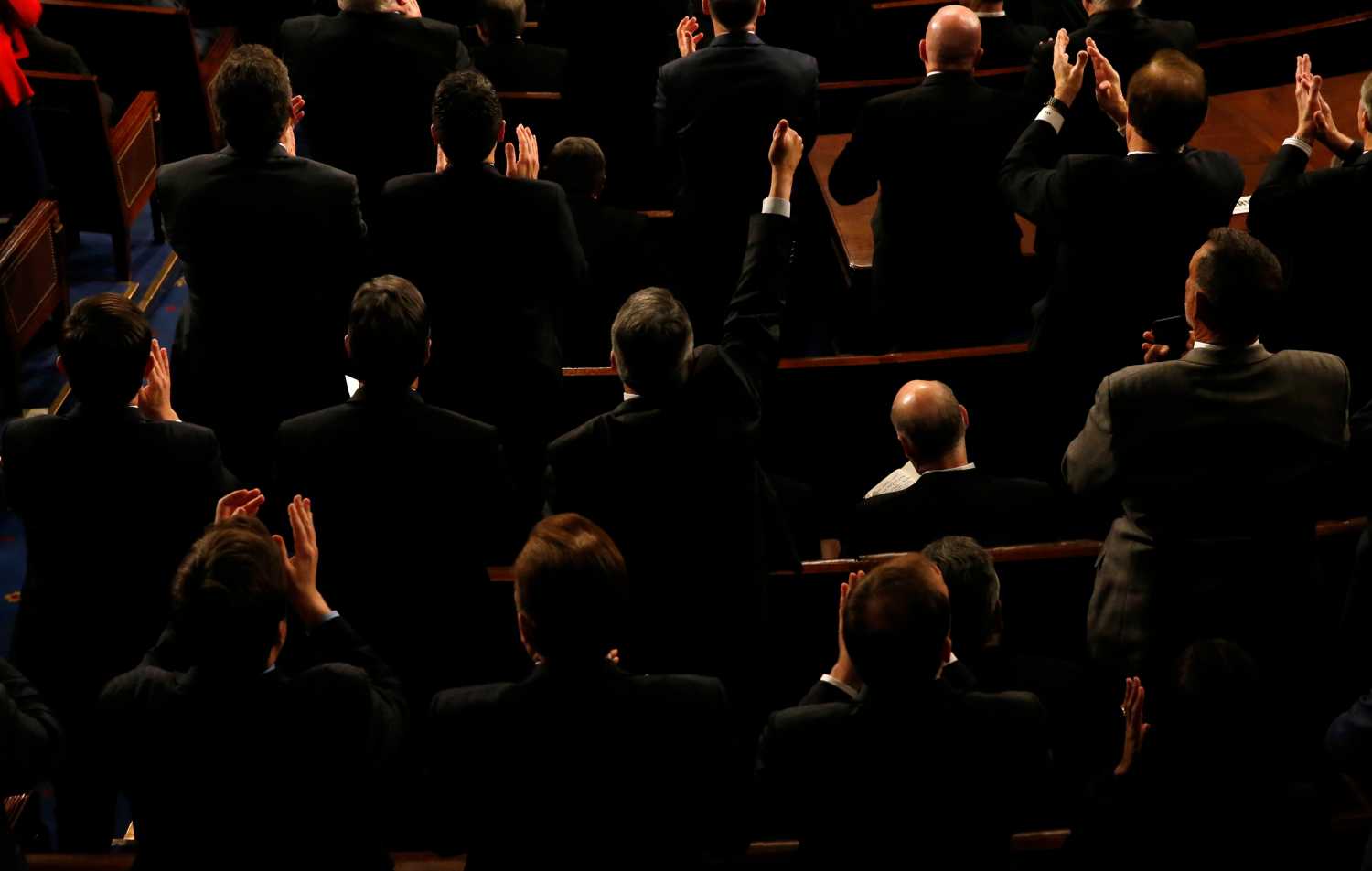 A Republican member of Congress gives a thumbs up while others applaud as U.S. President Donald Trump delivers his State of the Union address to a joint session of the U.S. Congress on Capitol Hill in Washington, U.S. January 30, 2018.